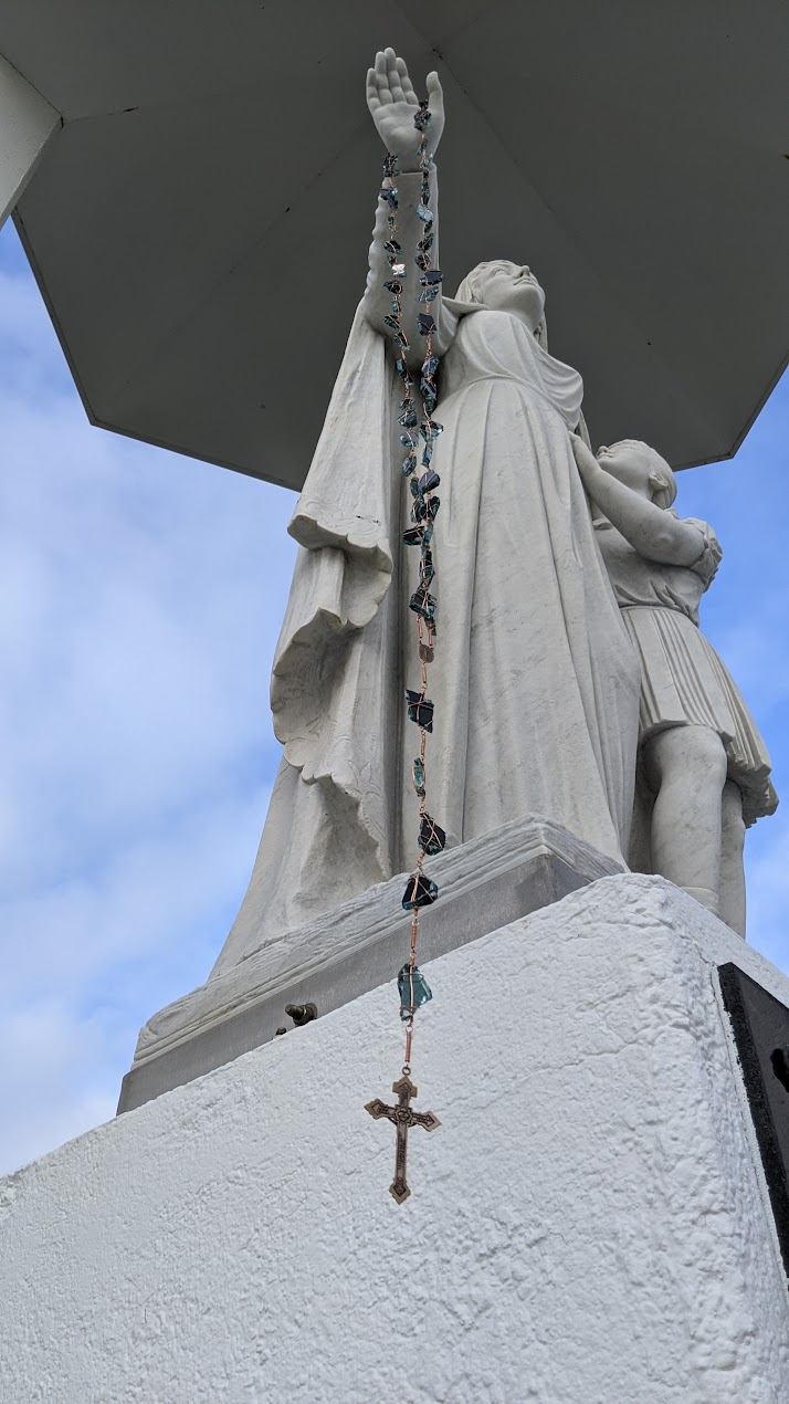 A rosary made with glass from the Capital One Building for Picking up the Pieces after Hurricane Laura